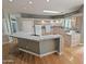 Expansive kitchen island with bar seating, tile countertops, light wood cabinets, and recessed lighting at 14236 N 28Th St, Phoenix, AZ 85032