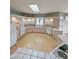 Bright kitchen featuring light wood cabinets, tile countertops, a skylight, and stainless steel appliances at 14236 N 28Th St, Phoenix, AZ 85032