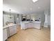 Open-concept kitchen with tile countertops, an island, stainless steel appliances, and hardwood floors at 14236 N 28Th St, Phoenix, AZ 85032
