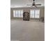 Large windows and a ceiling fan enhance this expansive living area with neutral walls and floors at 14236 N 28Th St, Phoenix, AZ 85032
