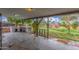 This covered back patio features a stone brick outdoor kitchen area and a view of the backyard at 14608 N Montego Ct, Phoenix, AZ 85053