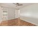 Bedroom features hardwood floors, a ceiling fan, and an attached bathroom at 14608 N Montego Ct, Phoenix, AZ 85053