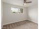Bedroom features carpet, ceiling fan, and large window at 14608 N Montego Ct, Phoenix, AZ 85053