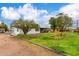 This is a view of the home's front yard and exterior with mature landscaping at 14608 N Montego Ct, Phoenix, AZ 85053