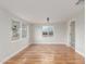 Open living room with hardwood floors, natural light, and white walls at 14608 N Montego Ct, Phoenix, AZ 85053