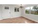 Open living room featuring hardwood floors, natural light, and new chandelier at 14608 N Montego Ct, Phoenix, AZ 85053