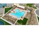 Aerial view of the community pool and clubhouse, surrounded by manicured landscaping and comfortable lounge chairs at 1464 E Aris Dr, Gilbert, AZ 85298