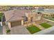 Stunning aerial view of a home with desert landscaping, stone accents, and a lovely green lawn at 1464 E Aris Dr, Gilbert, AZ 85298