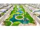 Beautiful aerial view of a park and community featuring ponds, lush green spaces, and pedestrian bridges at 1464 E Aris Dr, Gilbert, AZ 85298