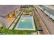 An aerial view of a backyard oasis featuring pool, fire pit, and meticulous landscaping with artificial grass at 1464 E Aris Dr, Gilbert, AZ 85298