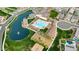 Aerial view of the community, showcasing a pool, clubhouse, playground, pond, and well-manicured lawns at 1464 E Aris Dr, Gilbert, AZ 85298