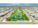 Beautiful aerial view of a community with manicured green spaces, ponds, and walking paths at 1464 E Aris Dr, Gilbert, AZ 85298