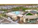 Aerial view of a community pool, clubhouse, and surrounding landscape, offering a vibrant and social gathering space at 1464 E Aris Dr, Gilbert, AZ 85298