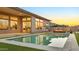 Inviting backyard featuring a pool, fire pit, and modern outdoor furniture, perfect for evening relaxation at 1464 E Aris Dr, Gilbert, AZ 85298