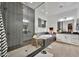 Modern bathroom featuring a glass-enclosed shower, a stylish bathtub, and elegant black and white tile work at 1464 E Aris Dr, Gilbert, AZ 85298