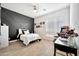Well-lit bedroom with wood-look floors, a modern accent wall, an arcade game, and stylish decor and furnishings at 1464 E Aris Dr, Gilbert, AZ 85298