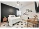 Well-lit bedroom with wood-look floors, a modern accent wall, and stylish decor and furnishings at 1464 E Aris Dr, Gilbert, AZ 85298