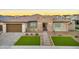 Beautiful home with stone accents, desert landscaping, and green lawns creating an inviting curb appeal at 1464 E Aris Dr, Gilbert, AZ 85298