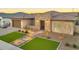 Inviting home with beautiful stone accents, desert landscaping, and manicured front lawn with an attached garage at 1464 E Aris Dr, Gilbert, AZ 85298