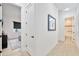 Hallway view with a framed jersey, leading to bedrooms and a bathroom at 1464 E Aris Dr, Gilbert, AZ 85298