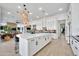 Open kitchen with a spacious island, stainless steel appliances, ample storage, and stylish pendant lighting at 1464 E Aris Dr, Gilbert, AZ 85298