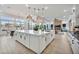 Modern kitchen featuring a large island, pendant lighting, stainless steel appliances, and a seamless transition into the living area at 1464 E Aris Dr, Gilbert, AZ 85298