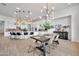 Open concept kitchen and dining area with an island, stainless steel appliances, and modern lighting fixtures at 1464 E Aris Dr, Gilbert, AZ 85298