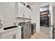 Well-equipped laundry room with modern washer and dryer, ample storage cabinets, and a practical sink area at 1464 E Aris Dr, Gilbert, AZ 85298