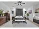 Serene main bedroom with a feature wall, neutral color scheme, and a cozy sitting area by the windows at 1464 E Aris Dr, Gilbert, AZ 85298