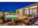 Night view of a stunning pool area with fire pit and modern furniture at 1464 E Aris Dr, Gilbert, AZ 85298