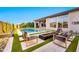Luxurious outdoor space with a pool, fire feature, and lounge chairs at 1464 E Aris Dr, Gilbert, AZ 85298