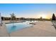 Resort-style community pool with sun loungers for relaxation, offering a refreshing oasis for residents at 1464 E Aris Dr, Gilbert, AZ 85298