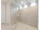 Modern shower with glass enclosure, multiple shower heads, tiled walls, and tiled floors at 17614 W Rancho Dr, Litchfield Park, AZ 85340