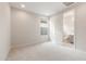 A bright bedroom leads to an attached bathroom, carpet, and an exterior window at 17614 W Rancho Dr, Litchfield Park, AZ 85340