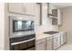 Stainless steel microwave and oven combination with grey cabinetry and quartz countertops at 17614 W Rancho Dr, Litchfield Park, AZ 85340