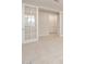 Open-concept space highlighted by glass paneled french doors and neutral tones at 17614 W Rancho Dr, Litchfield Park, AZ 85340