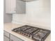 Gas stove top with five burners and stainless steel knobs at 17614 W Rancho Dr, Litchfield Park, AZ 85340