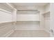 Walk-in closet with built-in shelving, carpeted floors, and ample storage space at 17614 W Rancho Dr, Litchfield Park, AZ 85340