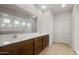 Bright bathroom features a double sink vanity with rich wood cabinets and large mirror at 17821 W Getty Dr, Goodyear, AZ 85338