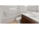 Clean bathroom with a tub-shower combination and a vanity with dark wood cabinets and a white countertop at 17821 W Getty Dr, Goodyear, AZ 85338