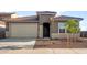 Charming single-story home with a well-manicured front yard, two car garage, and a beautiful tile roof at 17821 W Getty Dr, Goodyear, AZ 85338