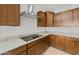 Close up of kitchen featuring stainless steel appliances, granite countertops, and dark wood cabinetry at 17821 W Getty Dr, Goodyear, AZ 85338