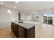 Open kitchen view of a center island with stainless steel sink and appliances at 17821 W Getty Dr, Goodyear, AZ 85338