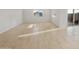 Open living room with neutral tile floors, white walls, and sliding glass door at 17821 W Getty Dr, Goodyear, AZ 85338