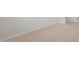 The basement is carpeted with neutral colored carpet and white trim and baseboards at 17845 W Getty Dr, Goodyear, AZ 85338