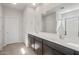 Bathroom featuring double vanity, large mirror, and walk-in shower at 17845 W Getty Dr, Goodyear, AZ 85338