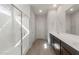 Bathroom showcasing walk-in shower with glass door and double sink vanity at 17845 W Getty Dr, Goodyear, AZ 85338