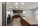 Modern kitchen boasts stainless steel appliances, granite countertops, and a functional island for meal prep at 17845 W Getty Dr, Goodyear, AZ 85338