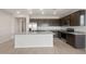 Spacious kitchen featuring stainless steel appliances, large island, and granite countertops at 17845 W Getty Dr, Goodyear, AZ 85338