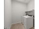 Functional laundry room featuring a washer, a dryer, neutral paint and tiled floor at 17845 W Getty Dr, Goodyear, AZ 85338